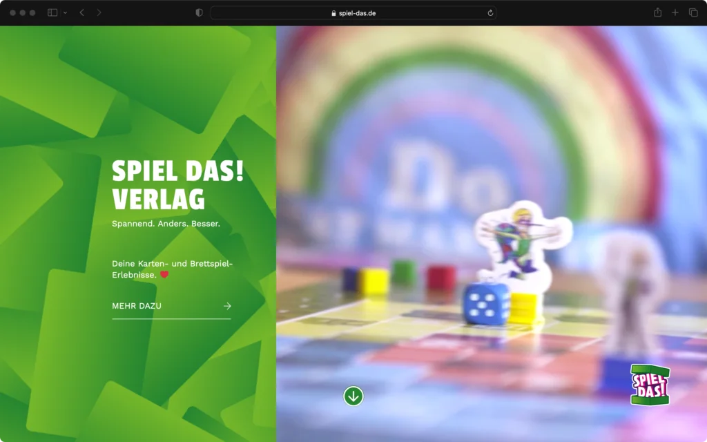 Screenshot einer Webseite mit grünem Bereich links und einem unscharfen Bild eines Brettspiels rechts, Text: Spiel Das! Verlag, Karten- und Brettspiel-Erlebnisse.